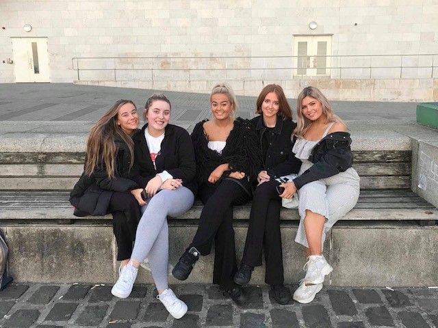 Image may contain: Woman, Girl, Park Bench, Suit, Overcoat, Bench, Female, Face, Blazer, Coat, Jacket, Jeans, Denim, Furniture, Person, Human, Sitting, Footwear, Shoe, Clothing, Pants, Apparel