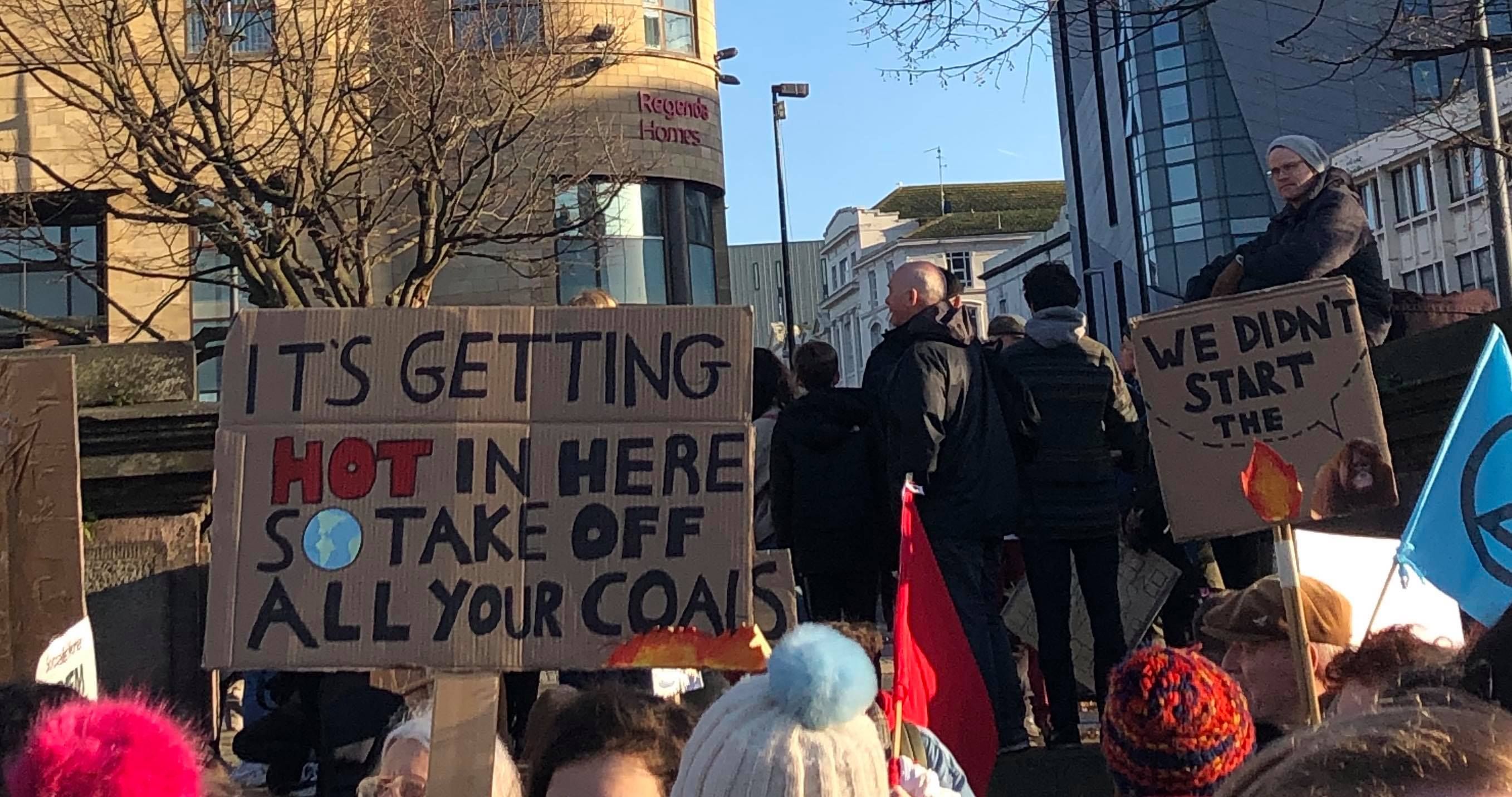 Image may contain: Crowd, Banner, Text, Human, Person