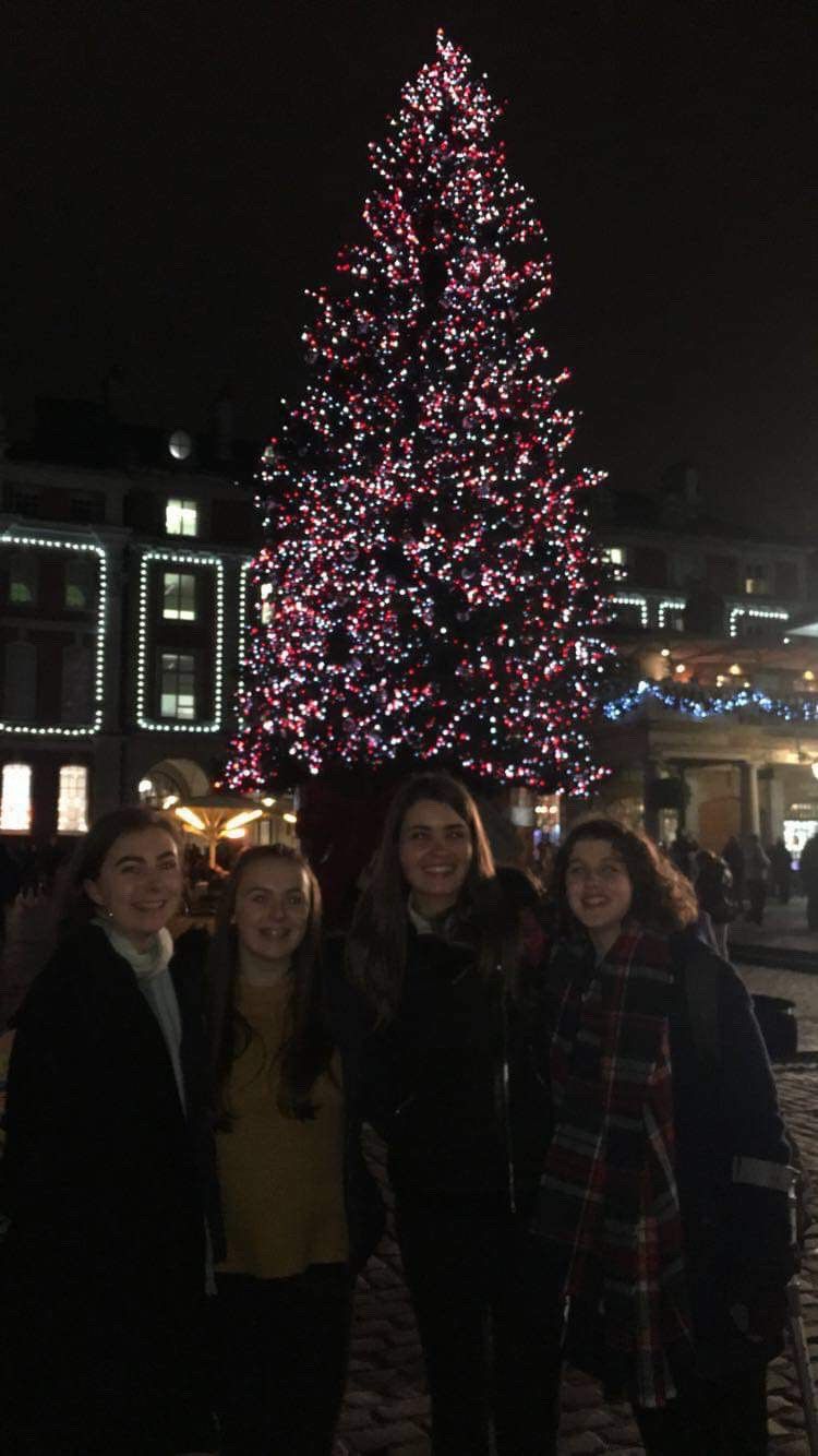 Image may contain: Lighting, Face, Clothing, Apparel, Human, Person, Night Life, Plant, Ornament, Tree, Christmas Tree