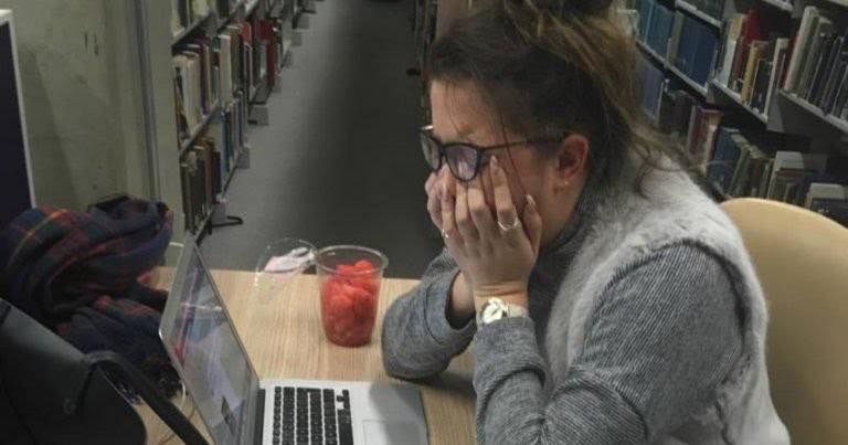 Image may contain: Library, Book, Hardware, Computer Keyboard, Computer Hardware, Keyboard, Face, Accessories, Accessory, Glasses, Room, Indoors, Laptop, Electronics, Pc, Computer, Person, Human