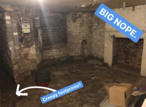 A damp and dark basement with the words BIG NOPE and Creepy Footprints?