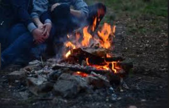 Image may contain: Person, People, Human, Leisure Activities, Flame, Fire, Camping, Campfire, Bonfire