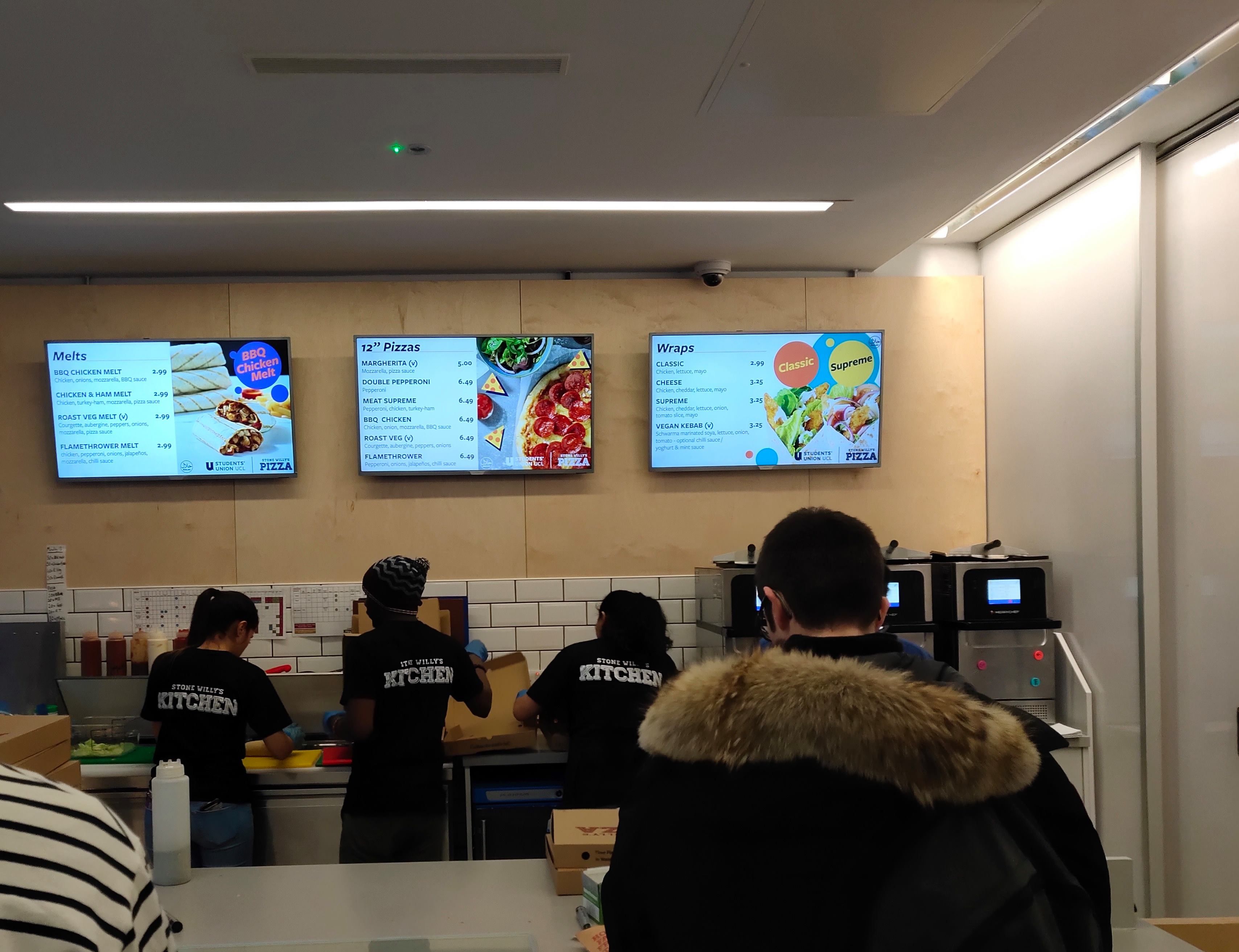 Image may contain: Cafeteria, Restaurant, LCD Screen, Projection Screen, Audience, Crowd, Display, Monitor, School, Room, Indoors, Classroom, Screen, Electronics, Person, Human