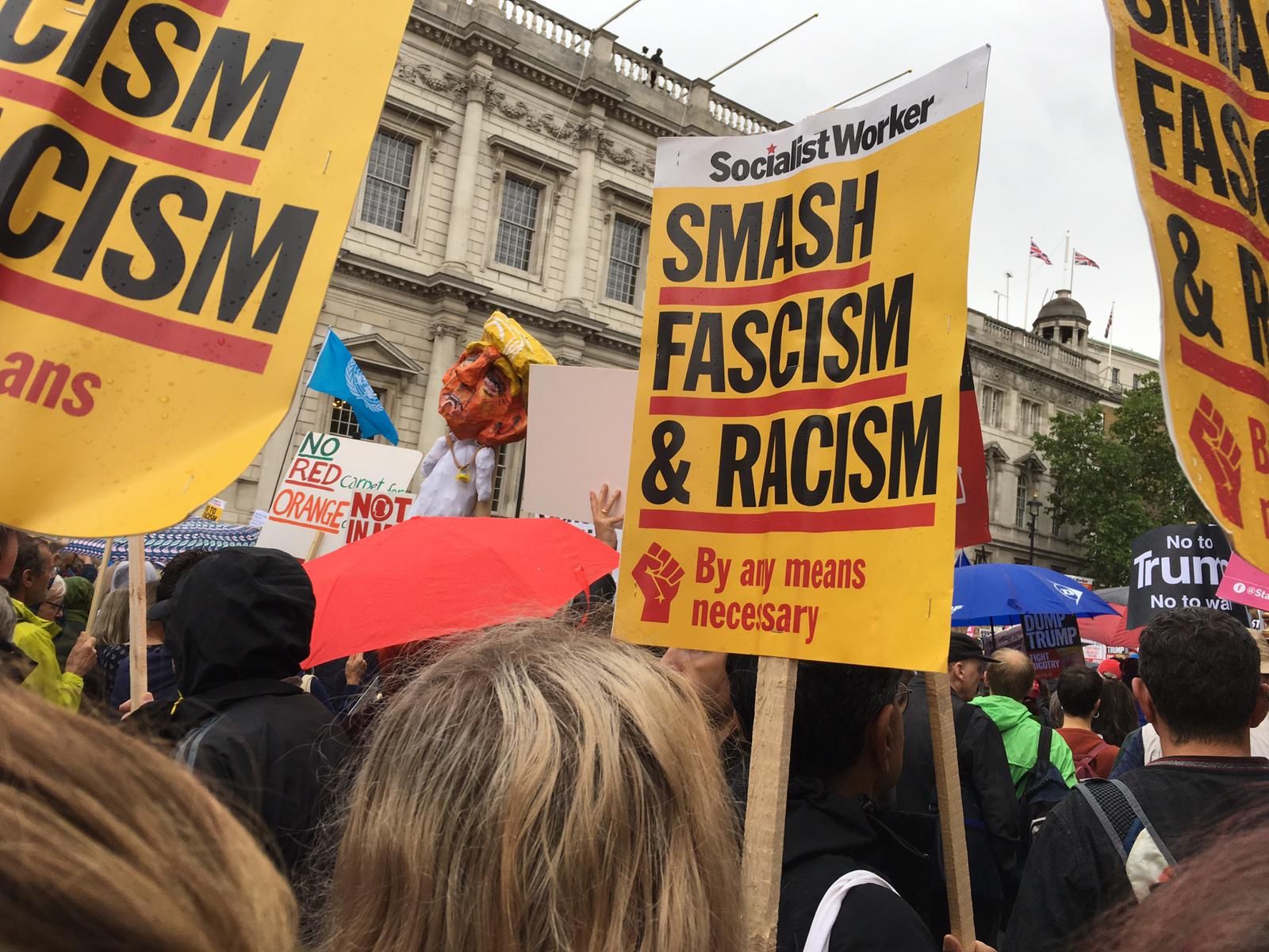 Image may contain: Crowd, Person, Human, Banner, Text