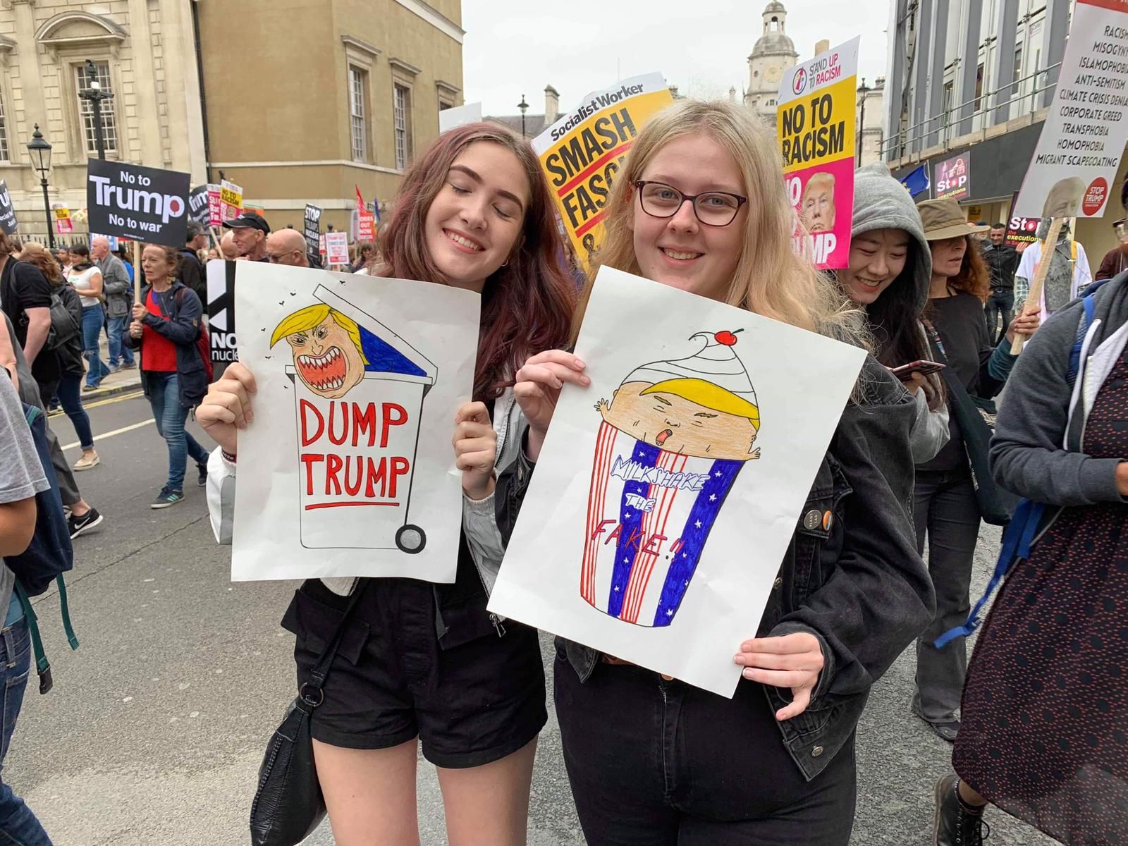 Image may contain: Shorts, Crowd, Banner, Text, Apparel, Shoe, Footwear, Clothing, Person, Human