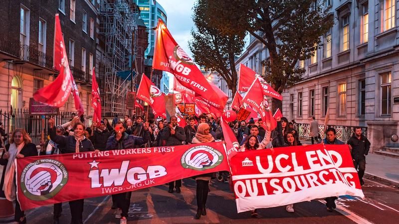 Image may contain: Flag, Symbol, Crowd, Human, Person, Banner, Text