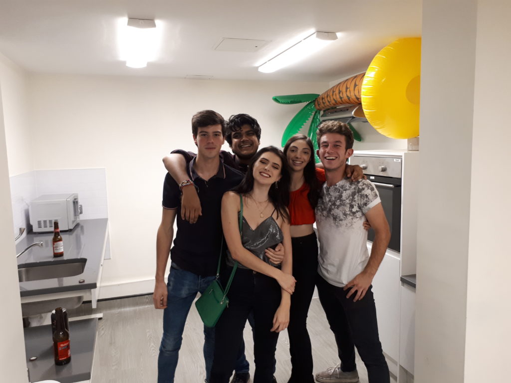 Five people in a kitchen for pres