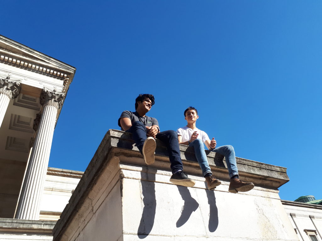 Two students sitting in UCL's main campus
