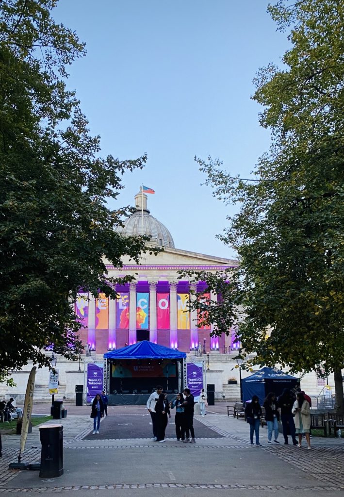 Vertical photo of UCL's Portico with empty stall in front.
