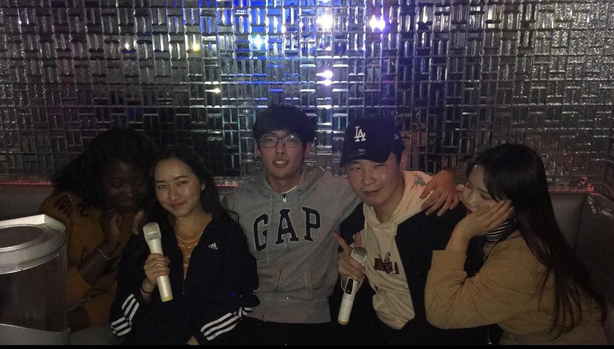 Image may contain: Pants, Night Club, Alcohol, Lighting, Club, Drink, Beverage, Face, Night Life, Clothing, Apparel, Electrical Device, Microphone, Bar Counter, Pub, Human, Person