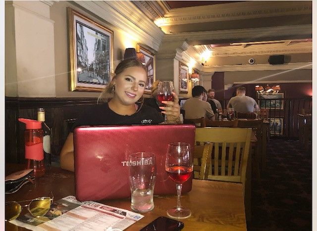 Image may contain: Room, Pub, Indoors, Dish, Cafe, Alcohol, Female, Face, Food Court, Glass, Meal, Food, Chair, Drink, Beverage, Table, Furniture, Dining Table, Restaurant, Human, Person