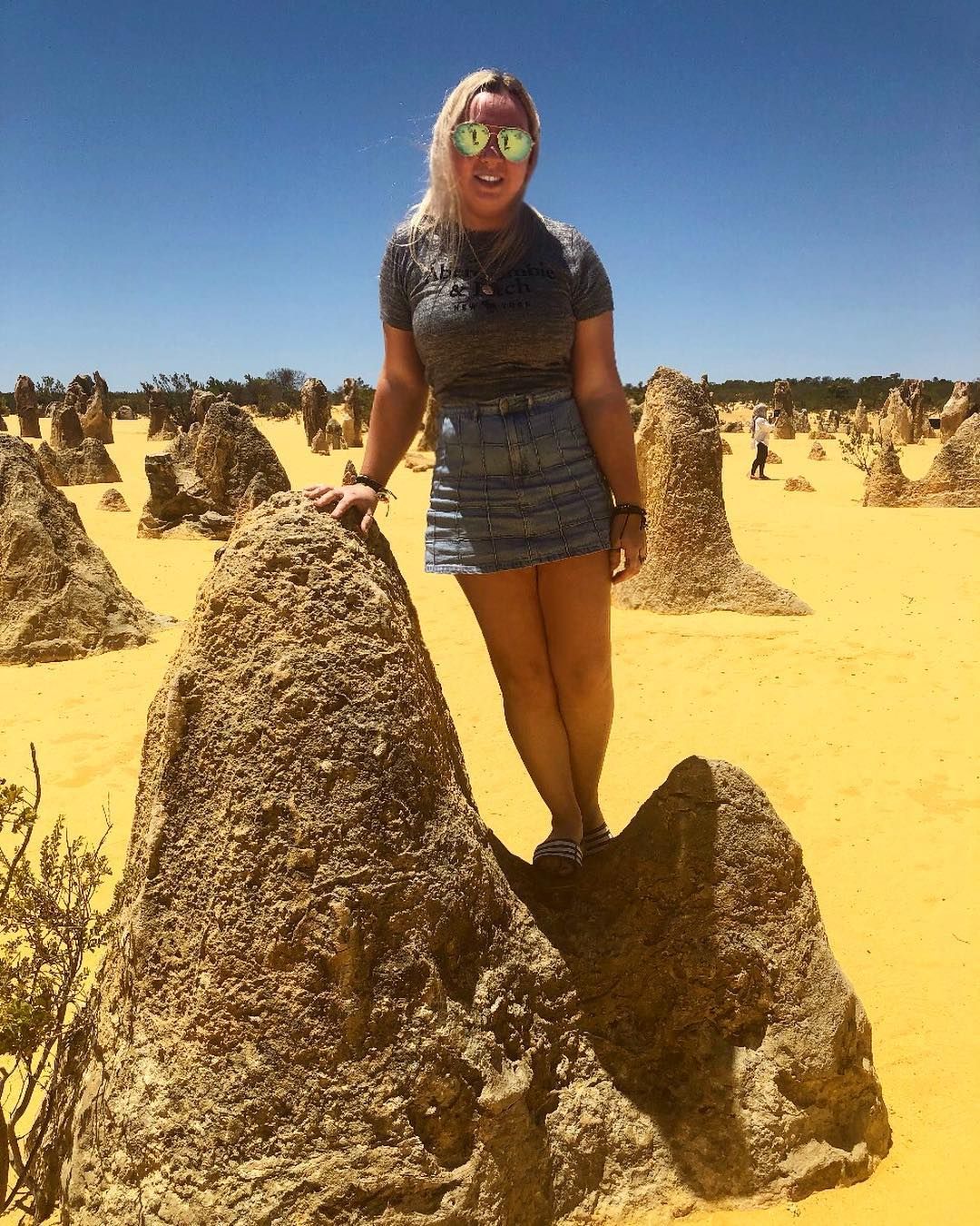 Image may contain: Woman, Rock, Dune, Accessories, Accessory, Sunglasses, Ground, Female, Desert, Shorts, Clothing, Apparel, Sand, Human, Person, Soil, Outdoors, Nature