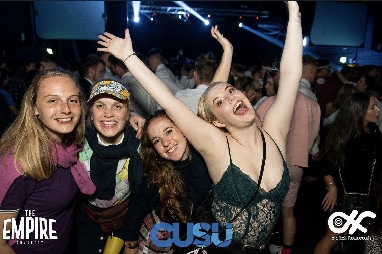Image may contain: Audience, Crowd, Smile, Apparel, Clothing, Lighting, Face, Night Club, Club, Night Life, Person, Human, Party