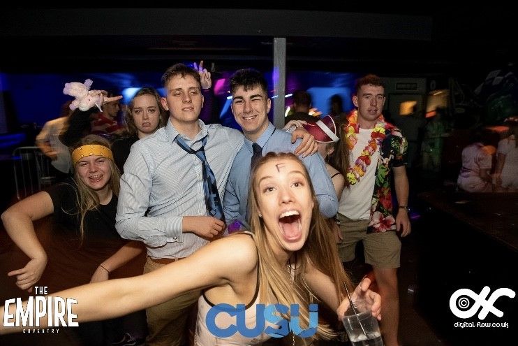 Image may contain: Dress, People, Woman, Photo, Portrait, Photography, Beverage, Drink, Head, Club, Crowd, Flower, Blossom, Smile, Night Life, Female, Plant, Clothing, Apparel, Face, Person, Human, Party