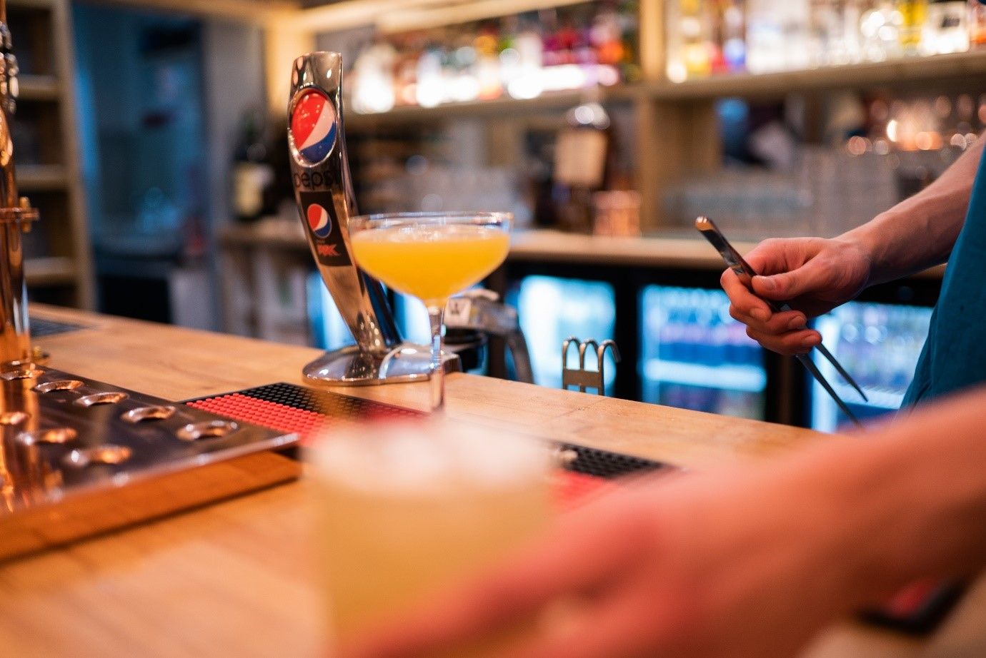 Image may contain: Cocktail, Hardwood, Beverage, Drink, Alcohol, Beer, Wood, Bar Counter, Person, Human, Pub
