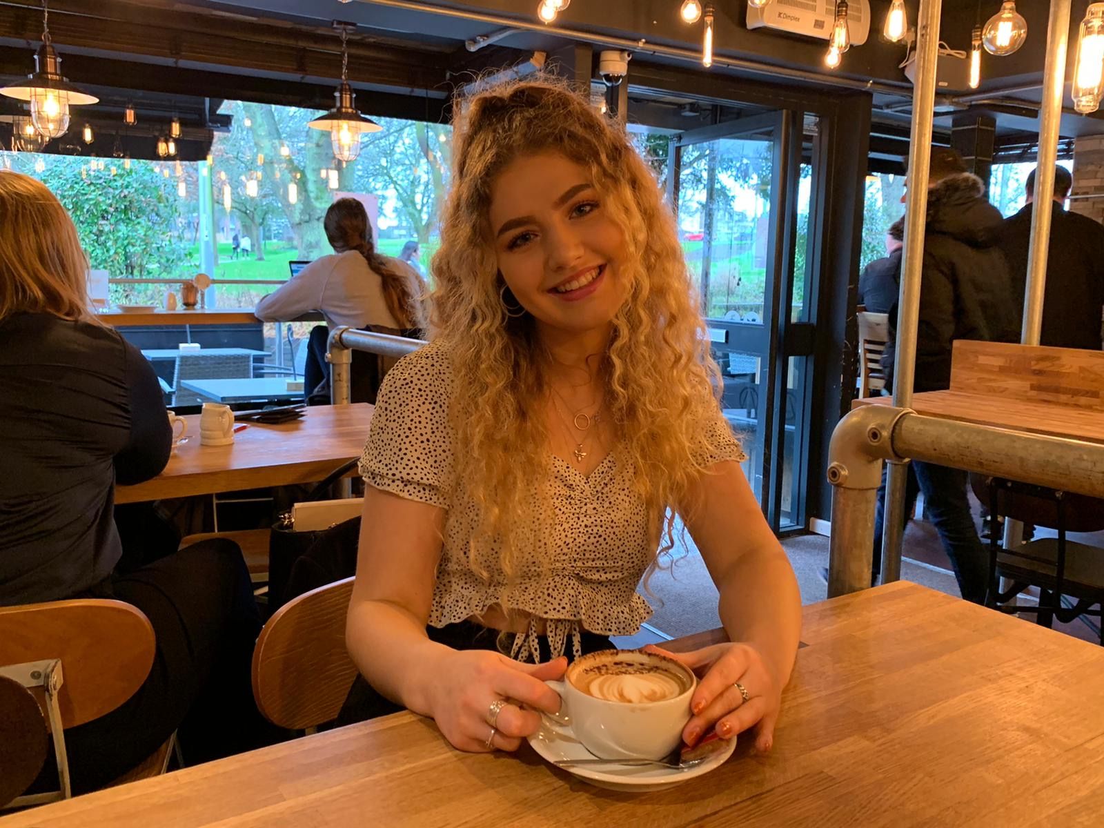 Image may contain: Shelf, Cafeteria, Coffee Cup, Cup, Food Court, Food, Cafe, Hardwood, Restaurant, Human, Person, Plywood, Wood