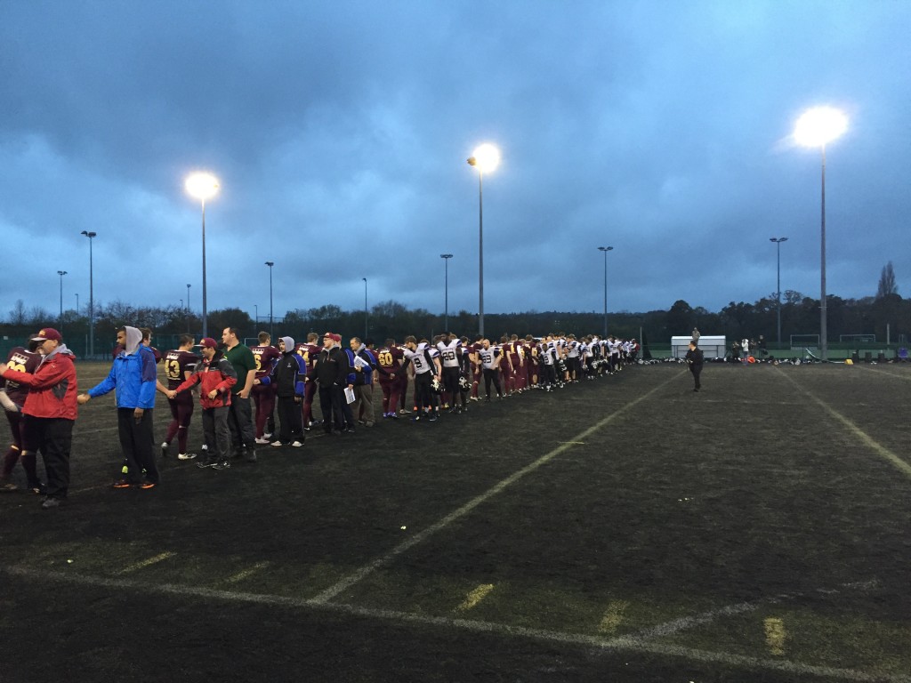 Game Over: The teams show respect to one another after a long battle lasting over two hours