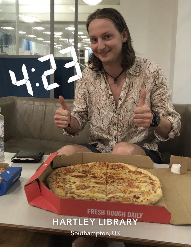Image may contain: Bottle, Indoors, Table, Furniture, Meal, Finger, Food, Pizza, Human, Person