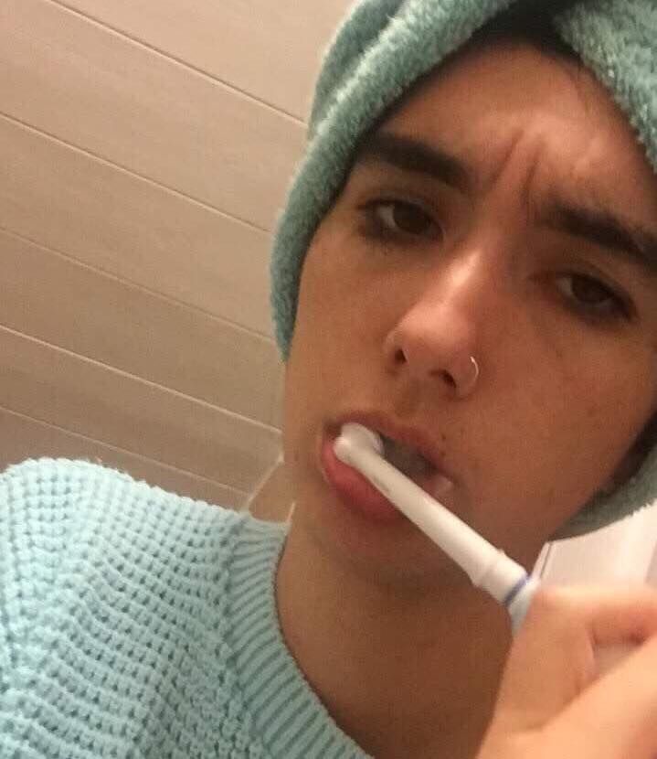 Image may contain: Tool, Toothbrush, Brush, Beanie, Hat, Cap, Face, Human, Person, Clothing, Apparel