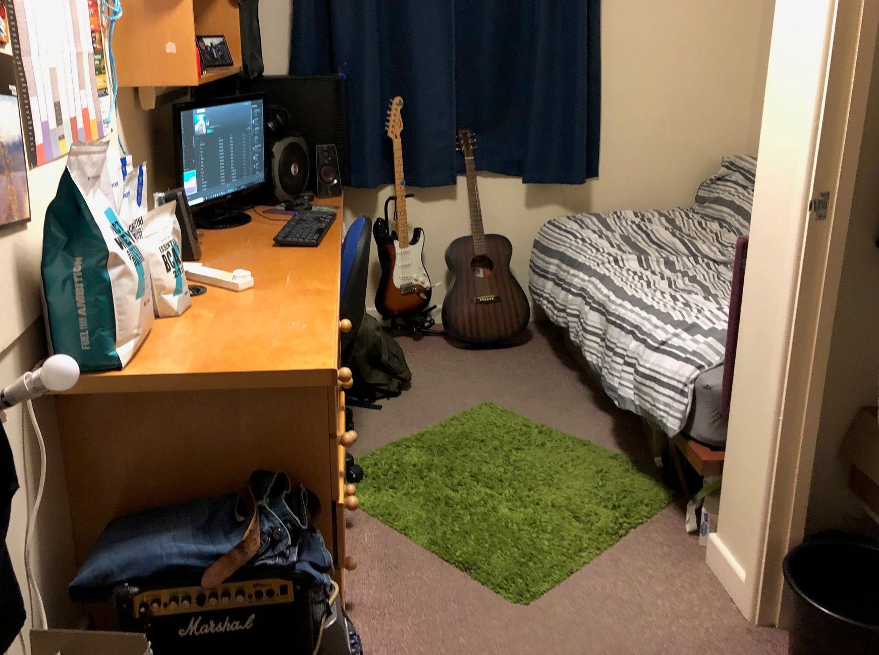 Image may contain: Computer, LCD Screen, Indoors, Room, Bedroom, Display, Screen, Monitor, Bed, Electronics, Leisure Activities, Musical Instrument, Guitar, Table, Desk, Furniture