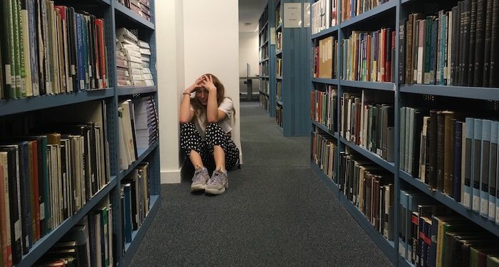 Image may contain: Home Decor, Shelf, Person, Human, Book, Library, Room, Indoors