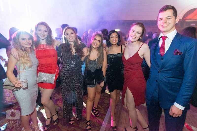 Image may contain: Night Life, Suit, Overcoat, Coat, Shorts, Female, Dress, Apparel, Clothing, Party, Night Club, Club, Human, Person, Tie, Accessory, Accessories
