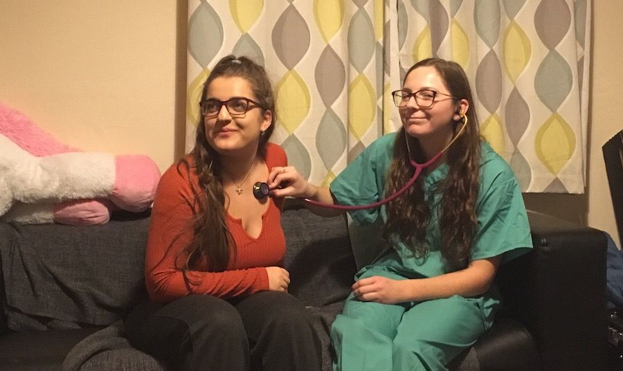 Image may contain: Woman, Portrait, Photography, Photo, Smile, Electronics, Female, Couch, Apparel, Clothing, Accessory, Glasses, Accessories, Furniture, Face, Human, Person