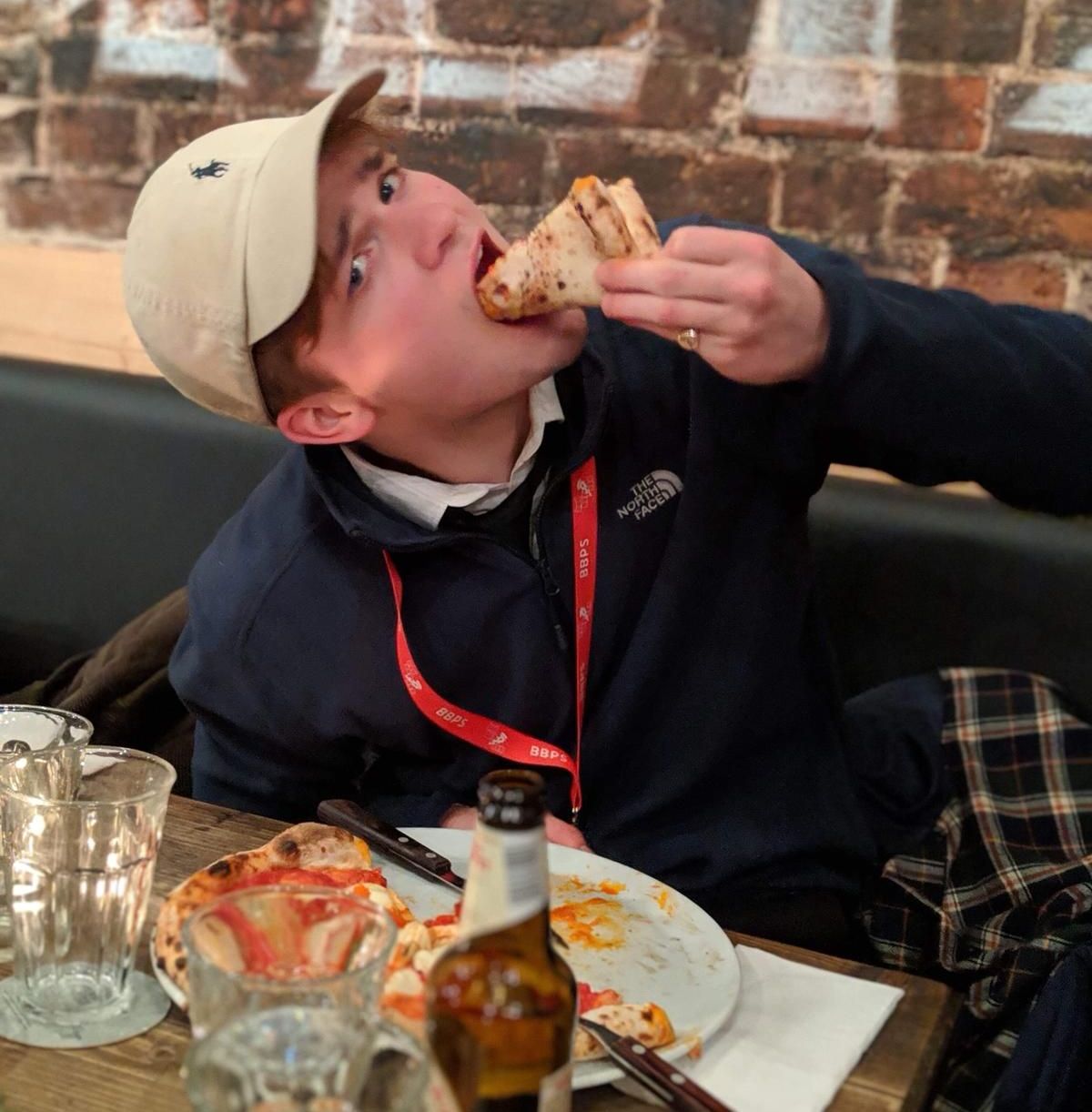 Image may contain: Food Court, Hat, Eating, Dish, Restaurant, Clothing, Apparel, Meal, Food, Human, Person
