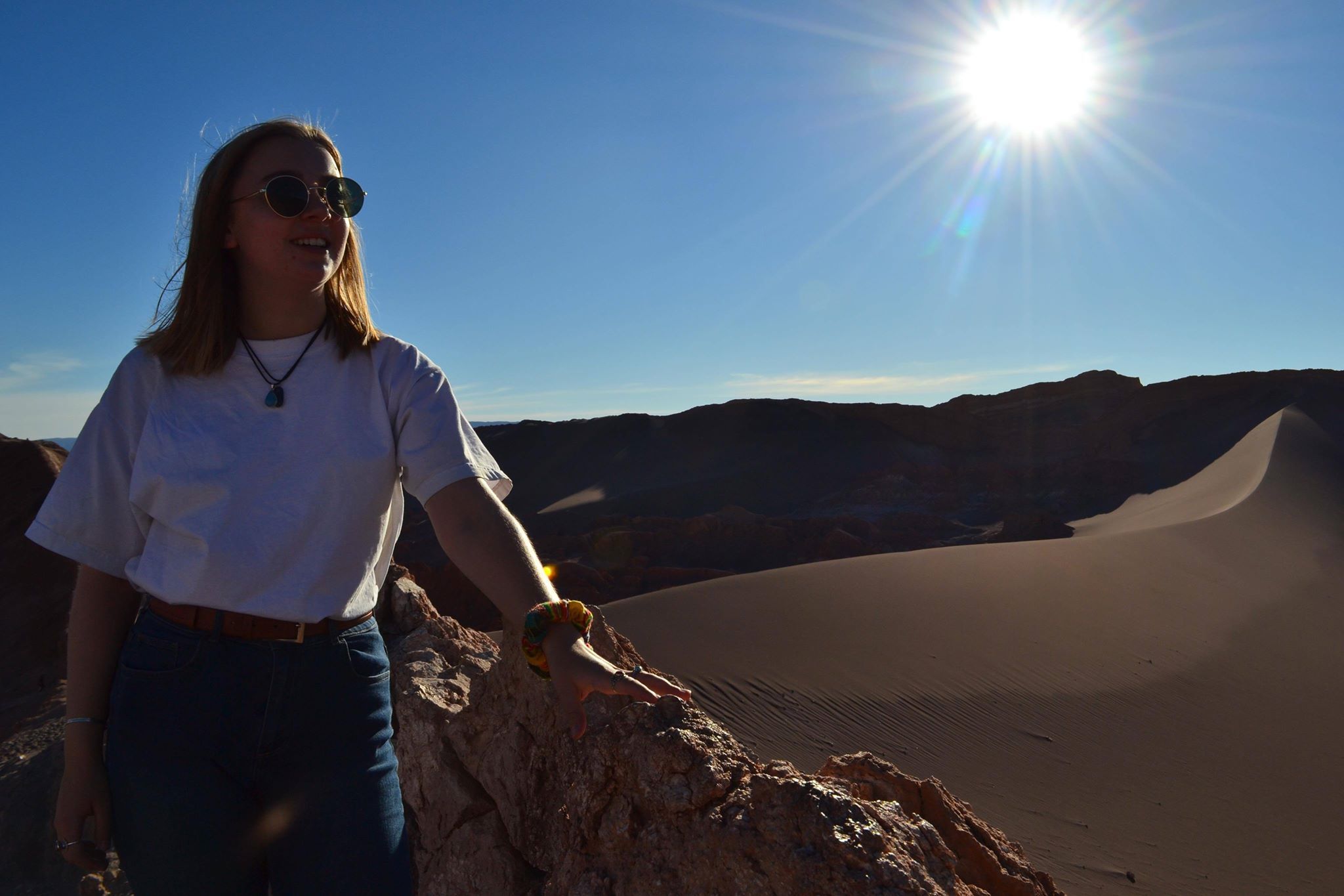 Image may contain: Soil, Sun, Sky, Light, Flare, Mountain, Adventure, Leisure Activities, Accessories, Sunglasses, Accessory, Human, Person, Nature, Outdoors