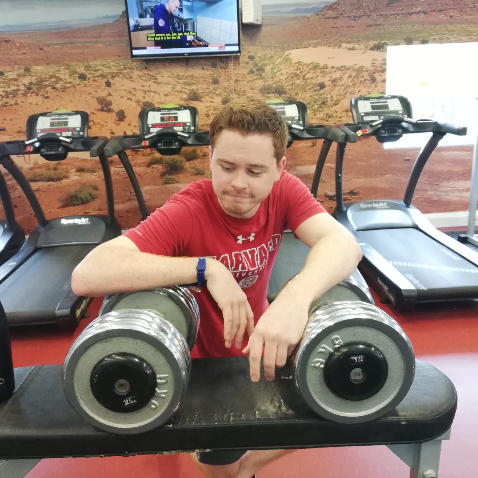 Image may contain: Automobile, Car, Shorts, Apparel, Clothing, Camera, Transportation, Vehicle, Screen, Fitness, Smile, Exercise, Working Out, Sports, Sport, Face, Electronics, Person, Human