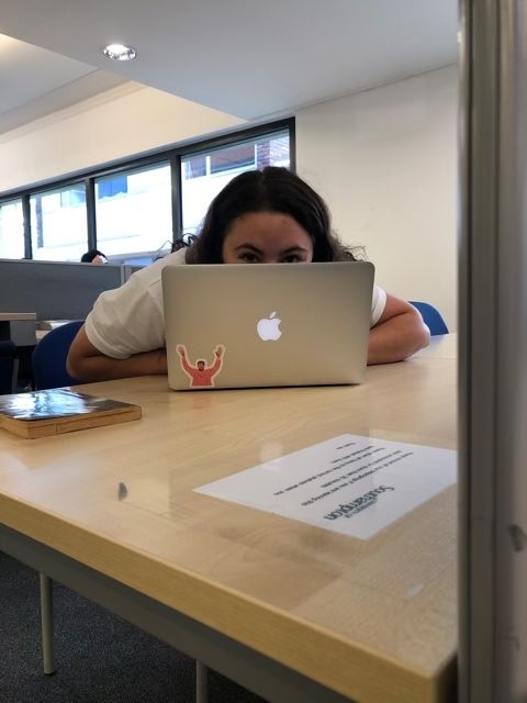 Image may contain: Dining Table, Chair, Face, Desk, Table, Human, Person, Laptop, Pc, Computer, Electronics, Tabletop, Furniture