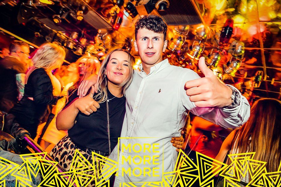 Image may contain: Night Life, Thumbs Up, Finger, Party, Night Club, Club, Person, Human