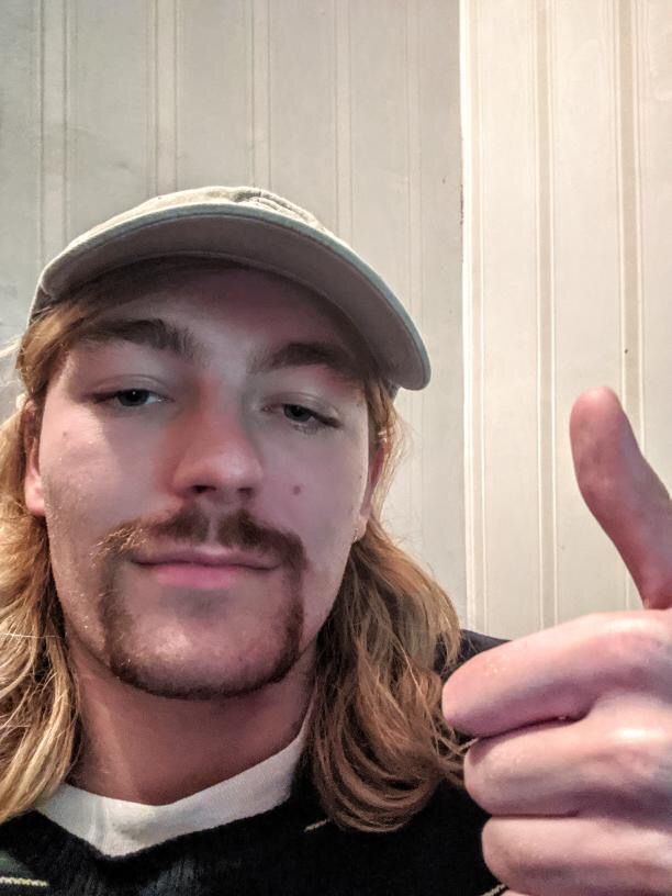 Image may contain: Clothing, Hat, Apparel, Photography, Photo, Portrait, Thumbs Up, Finger, Human, Person, Face