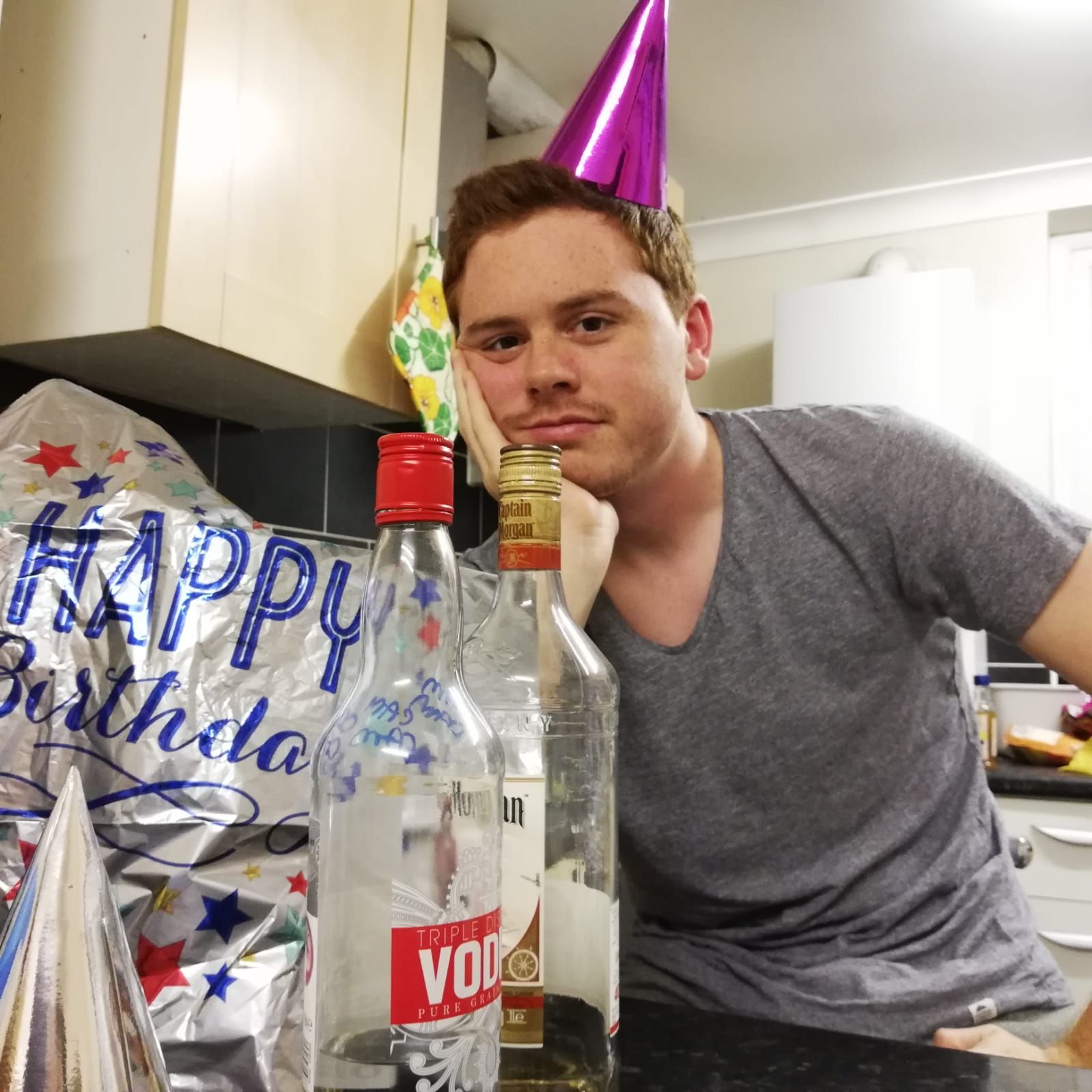 Image may contain: Drink, Beverage, Party Hat, Hat, Person, Human, Clothing, Apparel
