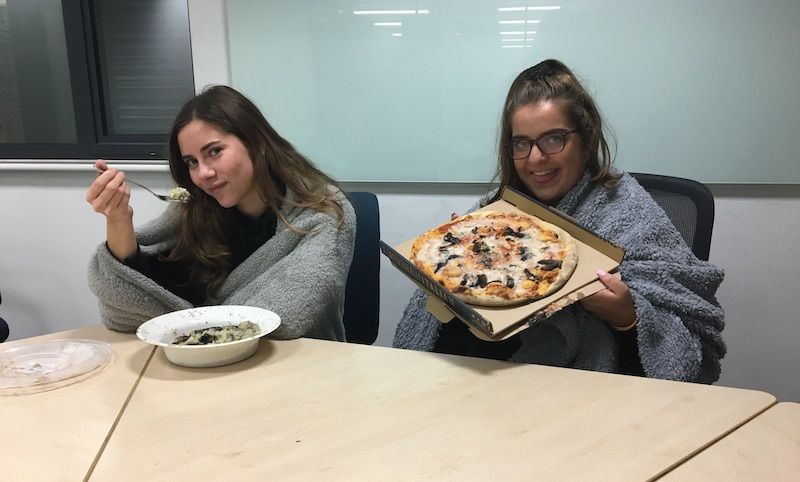 Image may contain: People, Glasses, Accessory, Accessories, Dining Table, Bowl, Coat, Suit, Overcoat, Female, Table, Apparel, Clothing, Face, Restaurant, Lunch, Tabletop, Furniture, Dish, Meal, Food, Pizza, Human, Person