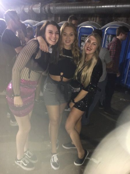 Image may contain: Crowd, Girl, Woman, Club, Dress, Footwear, Shoe, Shorts, Night Life, Face, Female, Clothing, Apparel, Person, Human
