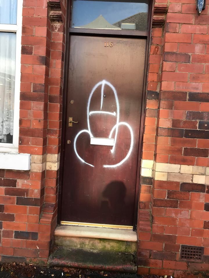 Image may contain: Plant, Logo, Trademark, Text, Symbol, Apparel, Clothing, Home Decor, Wall, Brick, Door