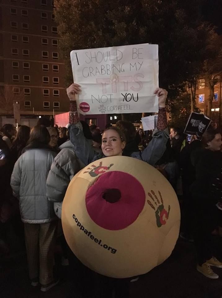 Image may contain: Clothing, Apparel, Text, Protest, Parade, Crowd, Human, Person