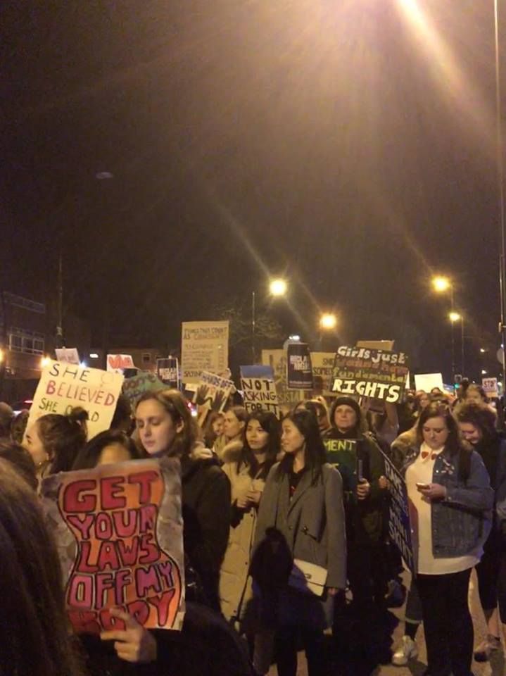 Image may contain: Offroad, Vehicle, Transportation, Text, People, Lighting, Crowd, Protest, Parade, Human, Person