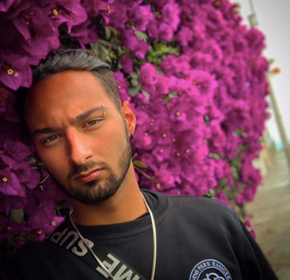 Image may contain: Purple, Portrait, Photo, Photography, Petal, Man, Flower, Blossom, Plant, Person, Human, Face