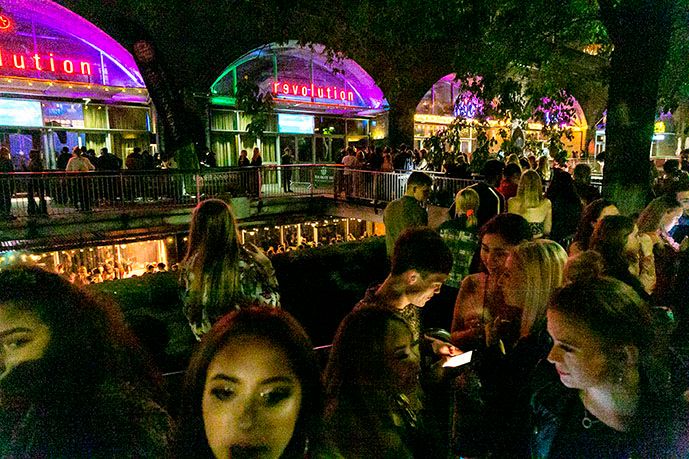 Image may contain: Food Court, Food, Outdoors, Bar Counter, Pub, Crowd, Restaurant, Person, Human, Lighting, Night Life