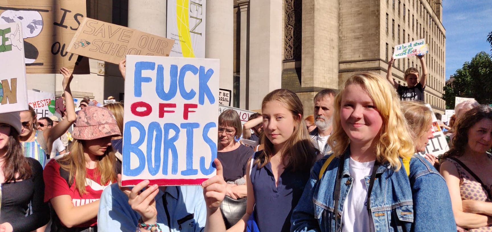 Image may contain: People, Banner, Accessories, Sunglasses, Accessory, Crowd, Text, Person, Human