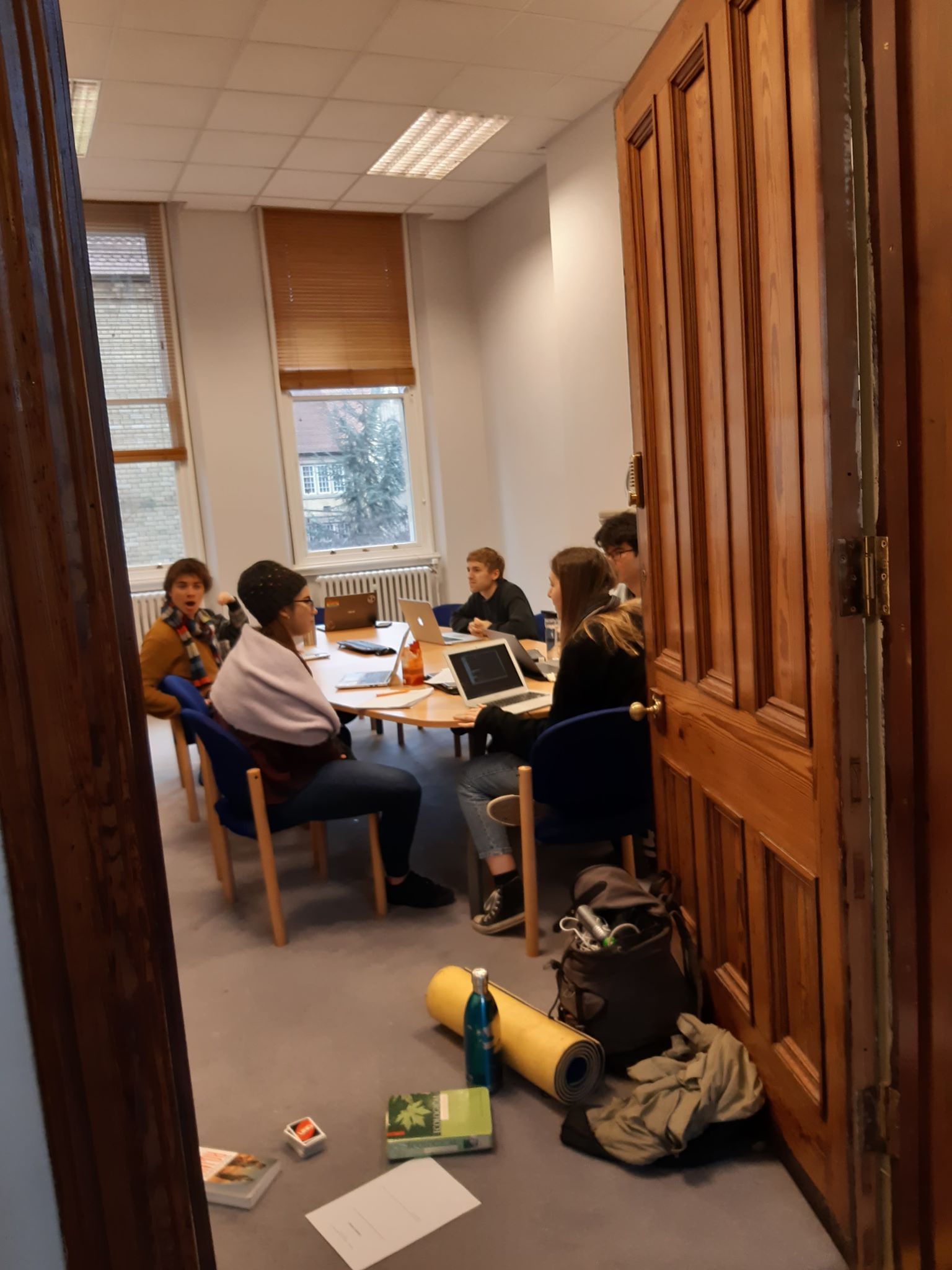 Image may contain: Hardwood, Door, Laptop, Pc, Electronics, Computer, Meeting Room, Conference Room, Clothing, Footwear, Apparel, Shoe, Flooring, Plywood, Wood, Indoors, Room, Human, Person, Chair, Furniture