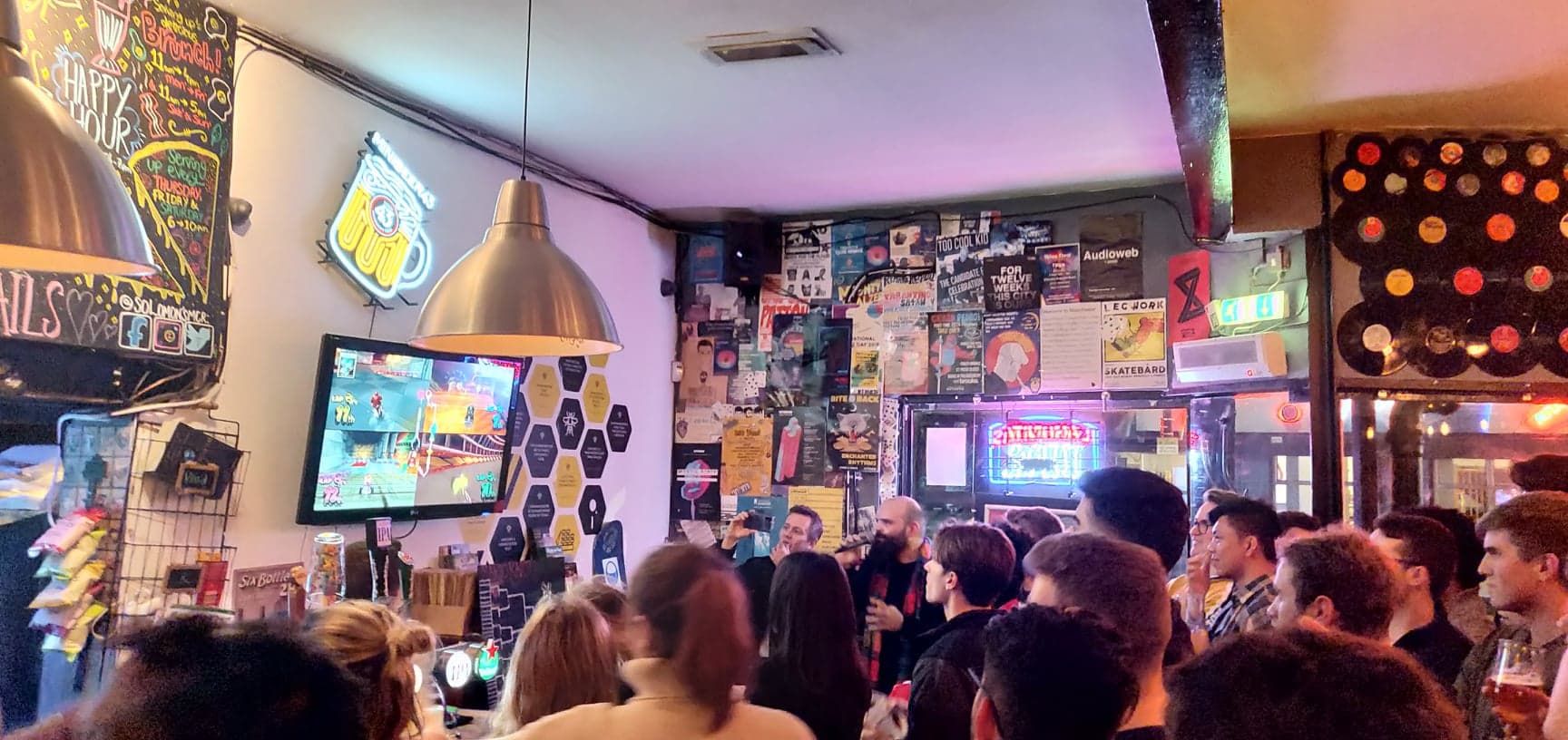Image may contain: Bar Counter, Television, TV, Restaurant, Pub, Crowd, LCD Screen, Screen, Electronics, Display, Monitor, Interior Design, Indoors, Human, Person