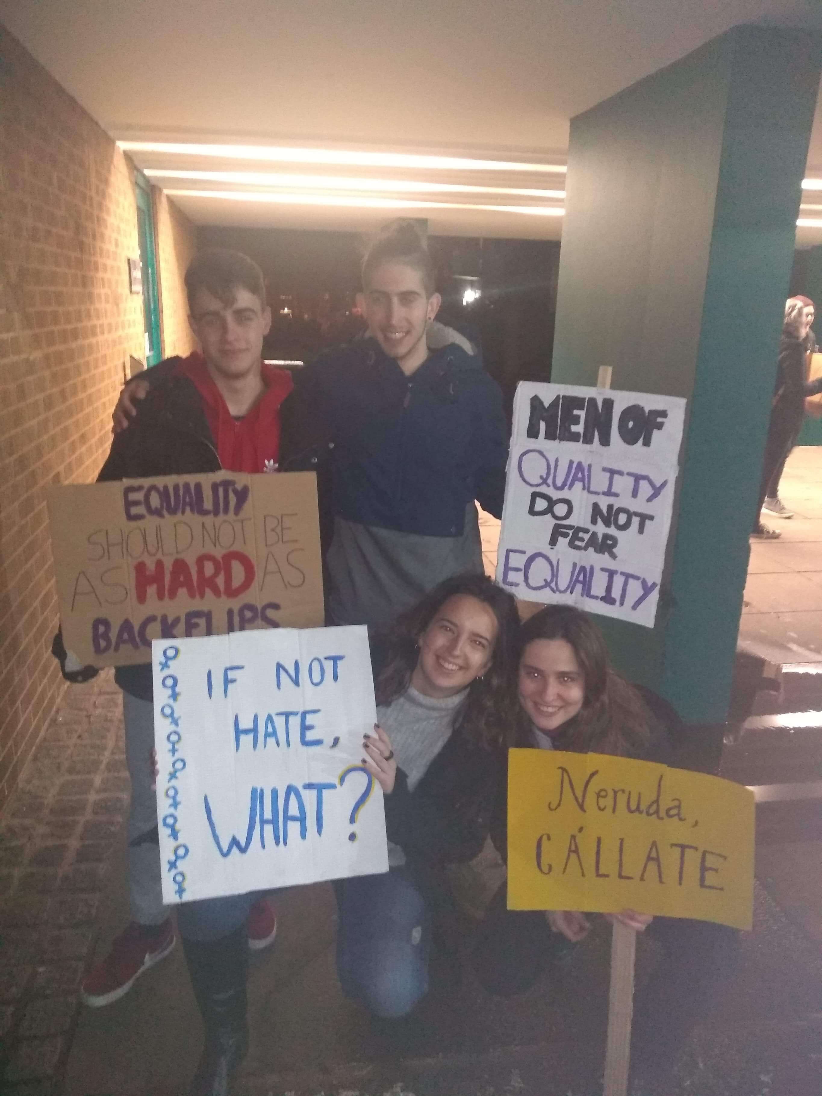 Image may contain: Crowd, Word, Banner, Clothing, Footwear, Apparel, Shoe, Person, Human, Text