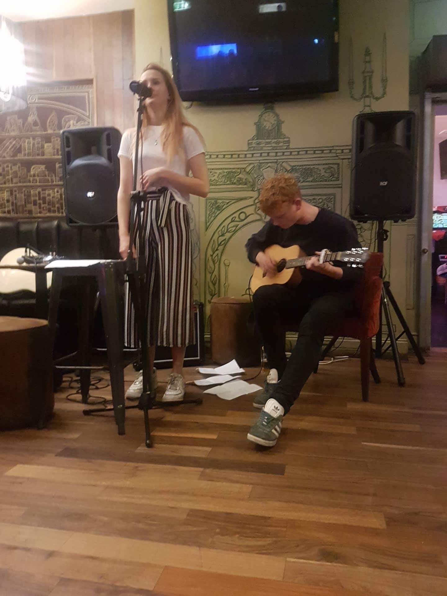 Image may contain: Flooring, Floor, Potted Plant, Plant, Performer, Musician, Musical Instrument, Guitarist, Guitar, Oven, Appliance, Human, Person, People