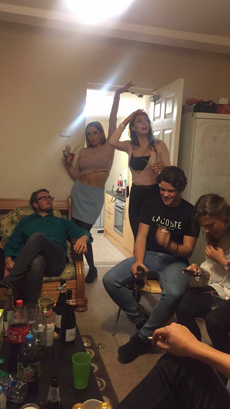 Image may contain: Furniture, Couch, Party, Crowd, Drink, Beverage, Alcohol, Cup, Human, Person, People