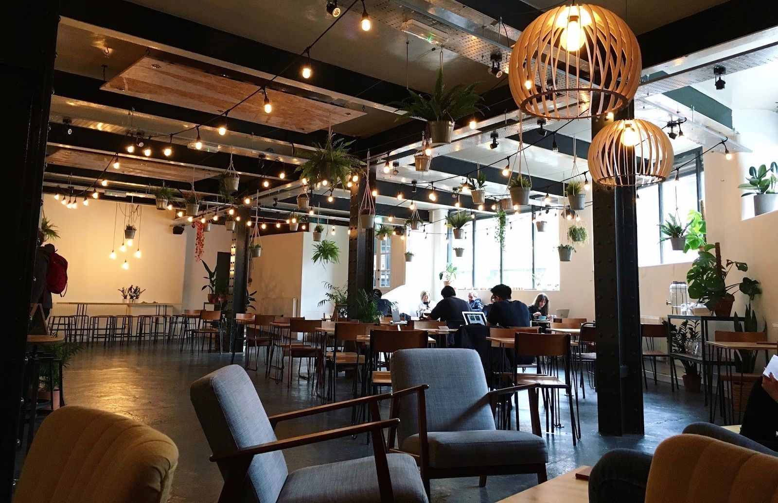 Image may contain: Wood, Plywood, Cafe, Restaurant, Room, Interior Design, Indoors, Dining Room, Vase, Pottery, Potted Plant, Plant, Jar, Flora, Couch, Furniture, Chair