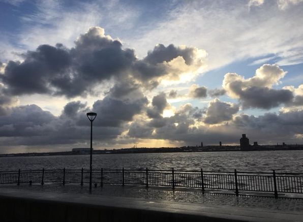 Image may contain: Railing, Sunlight, Flare, Light, Pier, Port, Dock, Waterfront, Water, Cumulus, Cloud, Sky, Weather, Outdoors, Nature