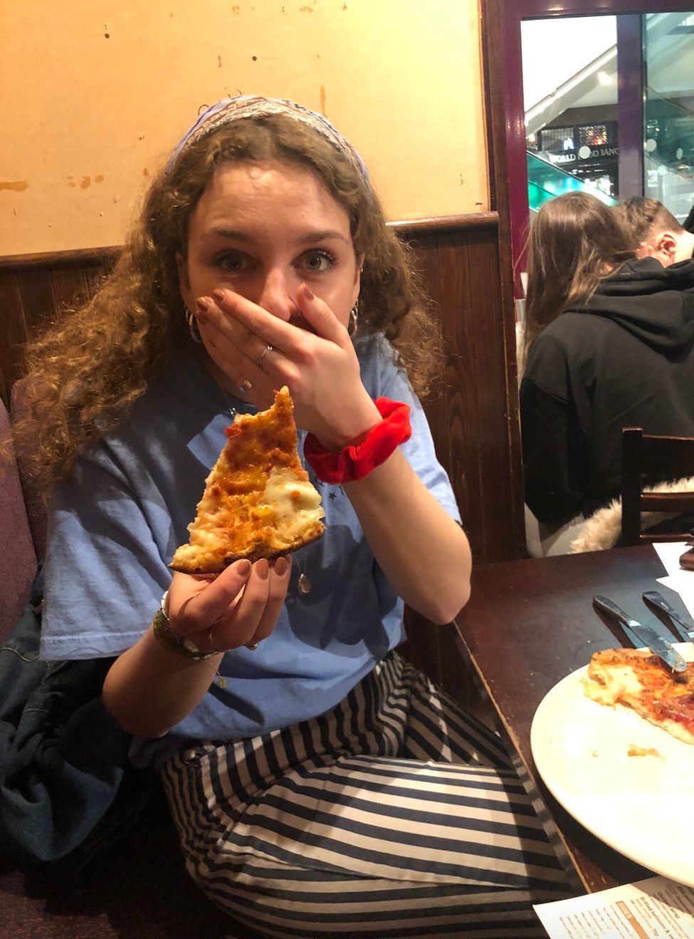 Image may contain: Restaurant, Eating, Pizza, Meal, Food, Human, Person